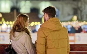 merry christmas, couple, young people, people, blonde, friendship, together, talking, fence, winter, holiday, lights, ornaments, decoration